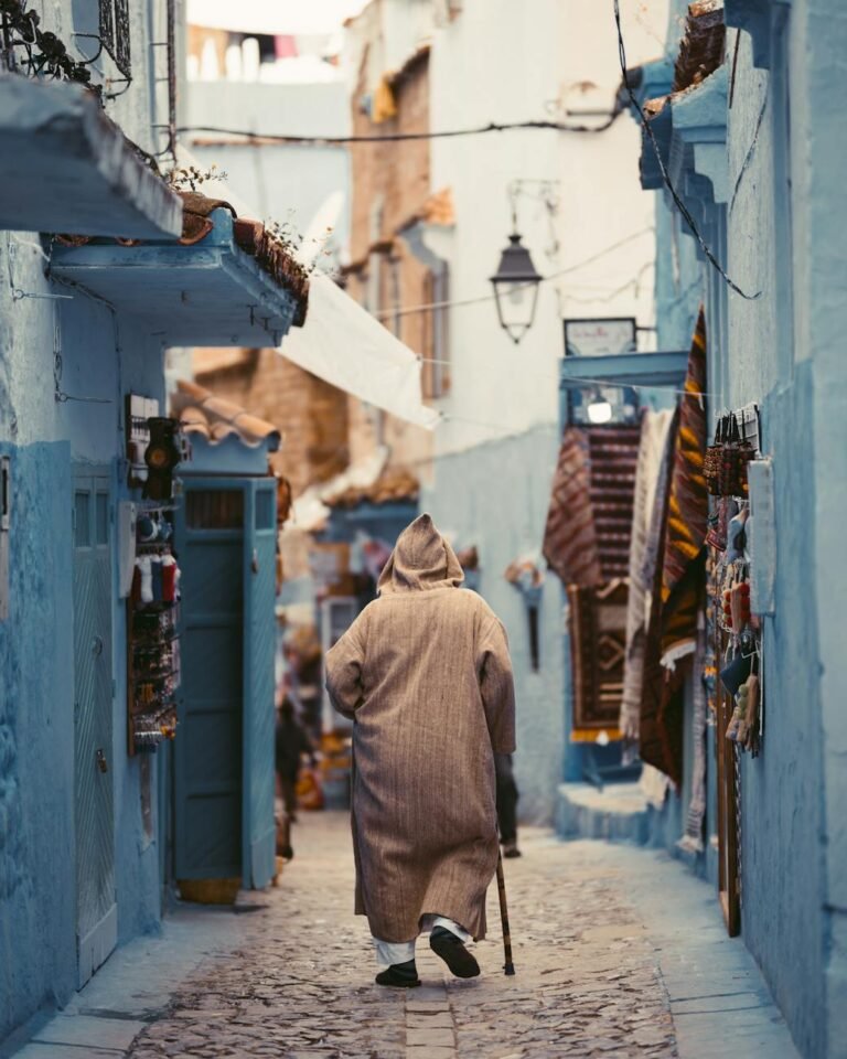 photo of person walking on alley